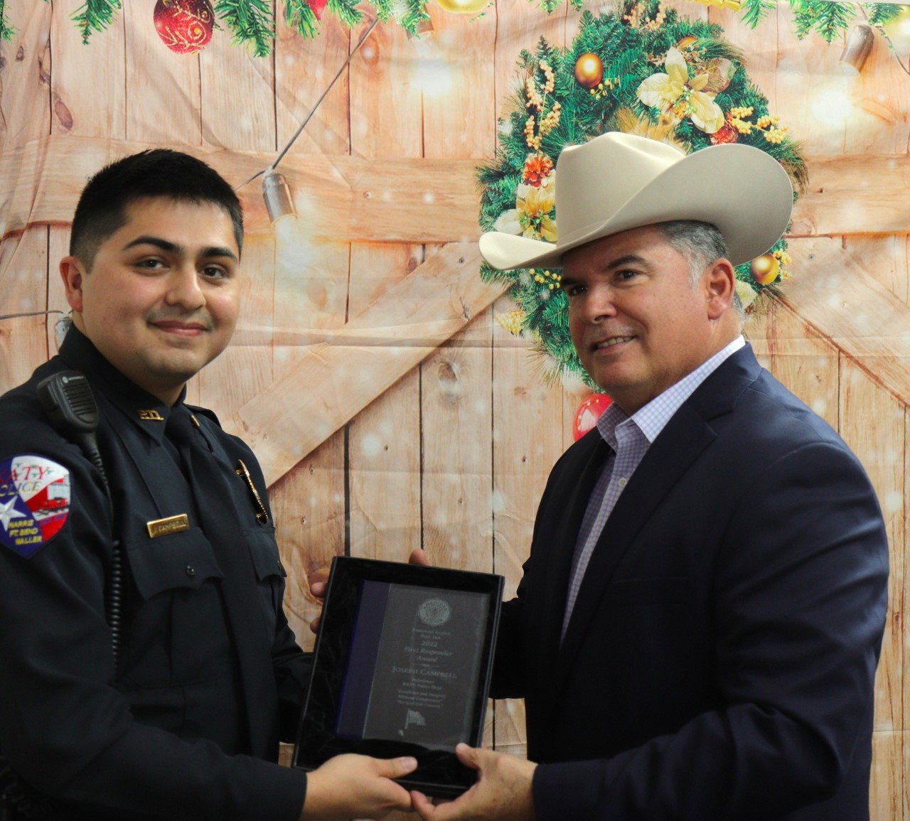 Katy Police officer Joseph Campbell receives congratulations from Police Chief Noe Diaz at the American Legion Post 164 First Responders Dinner, held Dec. 10 at the Elks Lodge, 1050 Katy Fort Bend Road.
